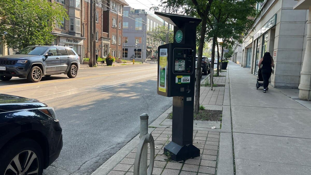 Green P meter parking machine for pay and display parking on Queen Street in the Beaches in Toronto.