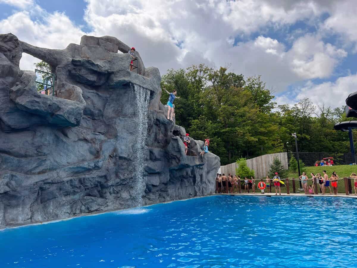 Visitors jumping off the Mountain Bay Cliffs at the Canada's Wonderland water park, Splash Works.