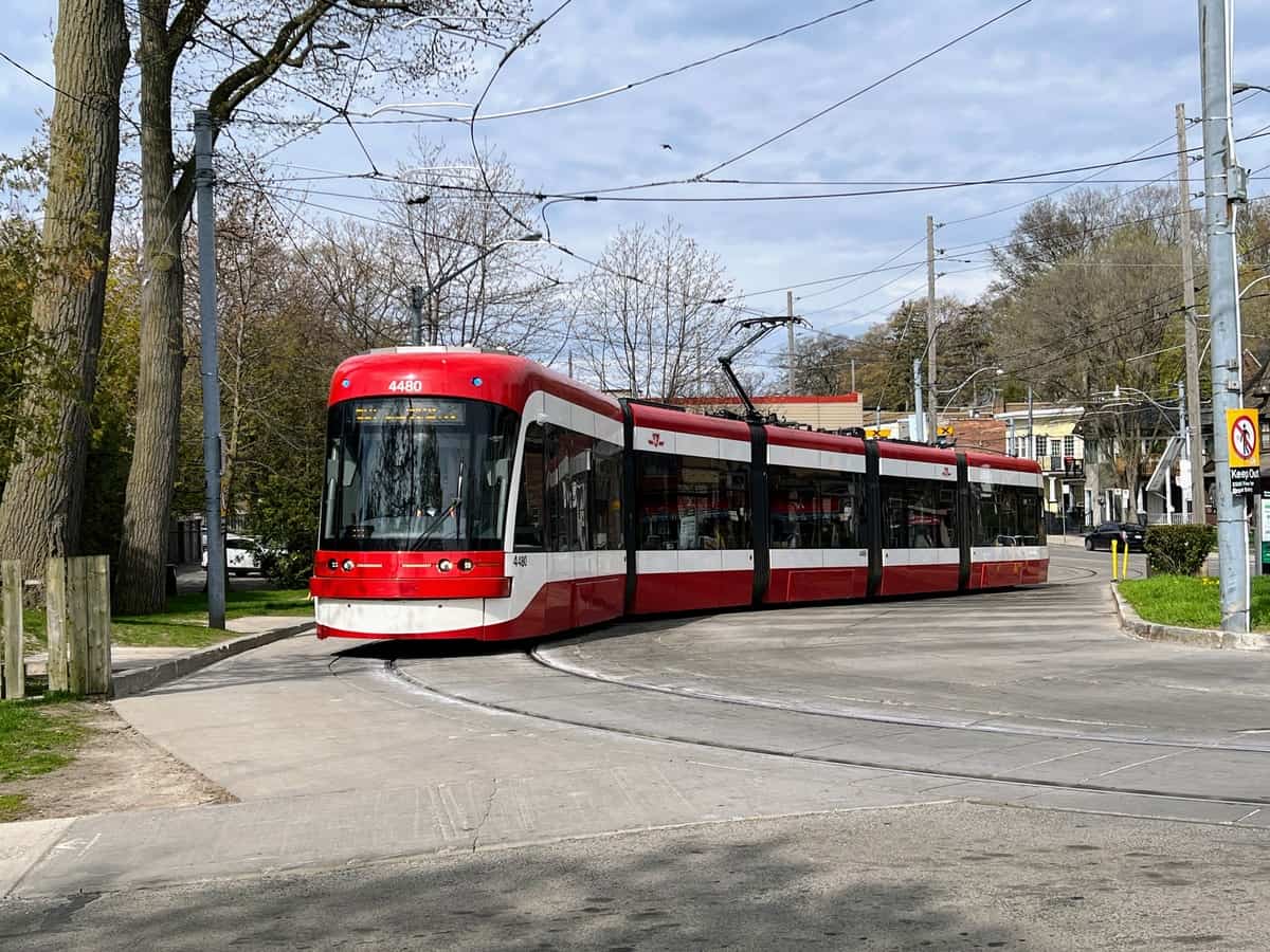 Toronto streetcar exiting the Neville Park Loop in the Beaches Neighbourhood on a bright, sunny summer day.