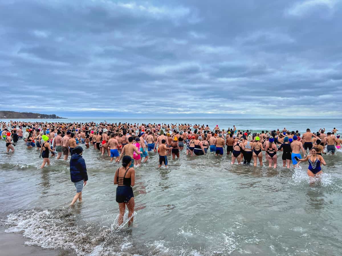 Hundreds of people enter Lake Ontario at Woodbine Beach in Toronto on New Year's Day to participate in the Polar Bear Plunge.