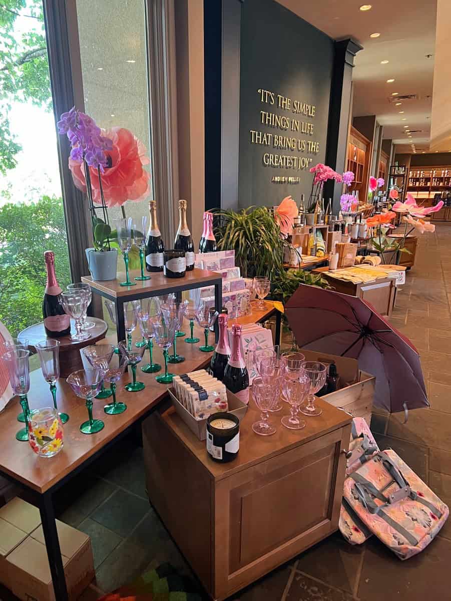 A display of glassware, champagne bottles, and floral decor in the Peller Estates boutique, perfect for picking up souvenirs from a visit to one of the NOTL wineries.