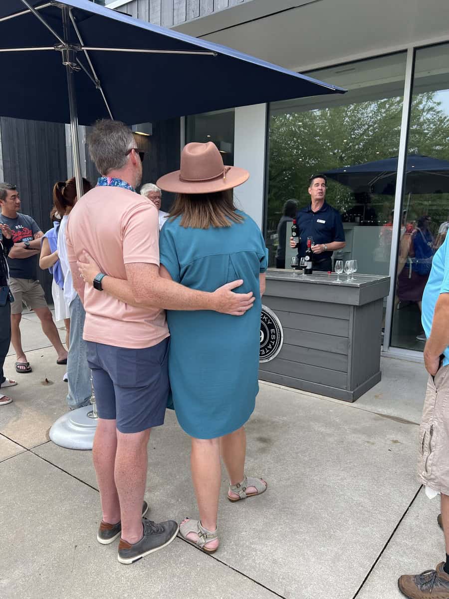 couple listens to a guide during a wine tasting tour at Wayne Gretzky Estates, enjoying an educational experience at this niagara on the lake winery.