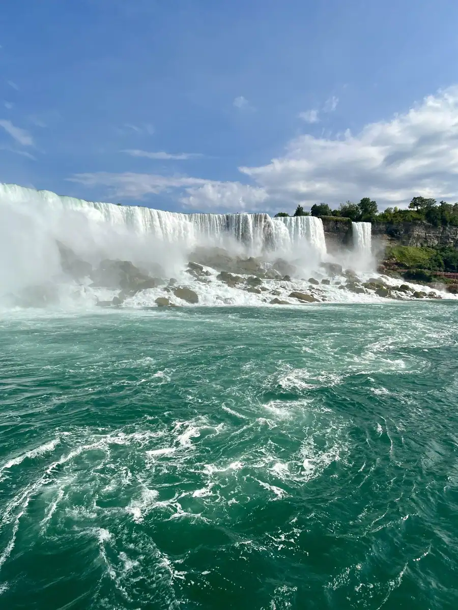 View of the American Falls taken from the Niagara Falls boat cruise on a bright summer day.