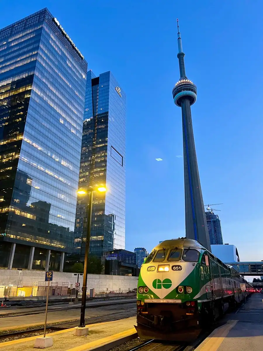 A GO Train parked at Union Station in downtown Toronto at dusk, part of the options for how to get around Toronto without a car.