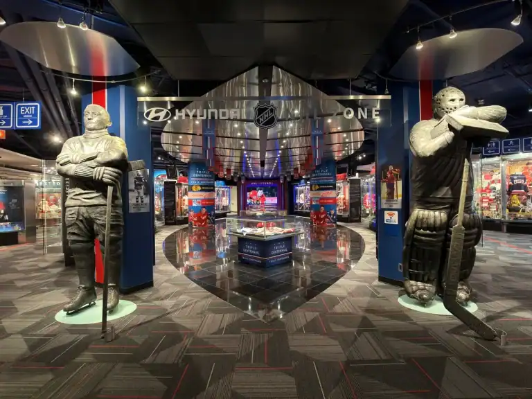 Entrance to the NHL Zone at the Hockey Hall of Fame in Toronto with large vintage-style hockey player statues.
