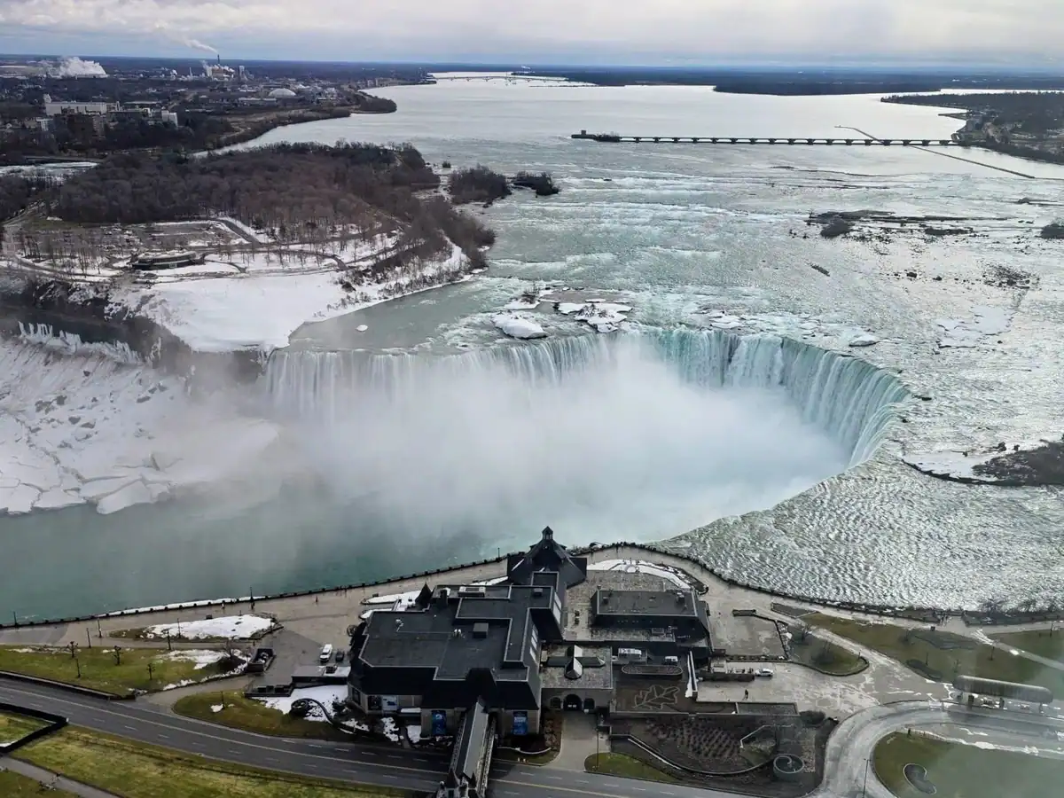Canadian Horseshoe Falls and Niagara Falls Welcome Centre are seen from a high floor of the Embassy Suites Hotel in Niagara Falls Canada during winter.
