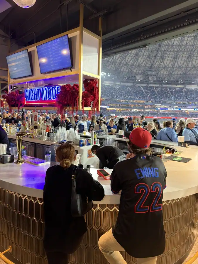 Fans stand at a bar inside the Rogers Centre during a Toronto Blue Jays baseball game.