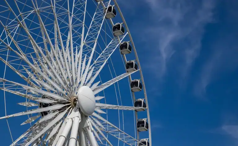 Close up view of the Niagara Falls ferris wheel, the SkyWheel, on a summer day with a blue sky in Niagara Falls Canada.