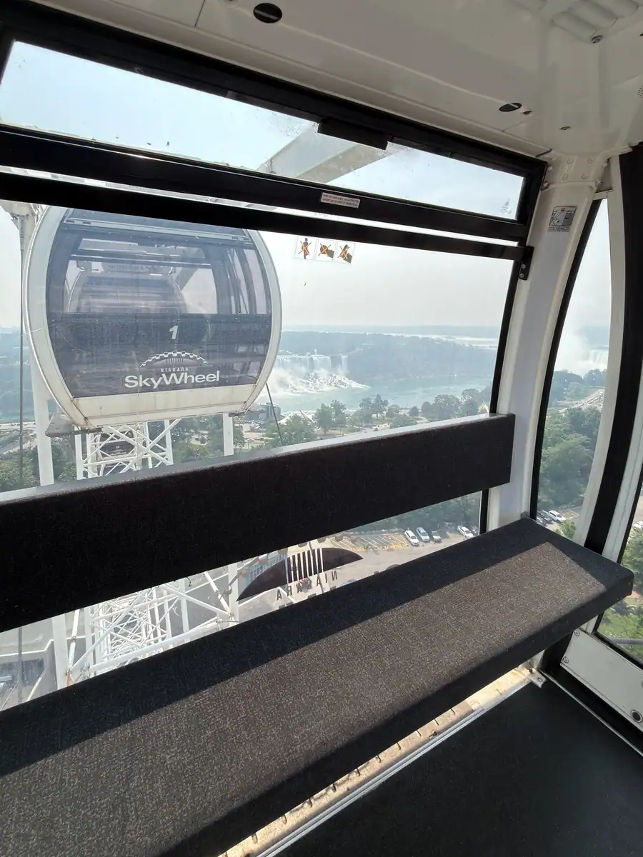 Inside of the gondola of the SkyWheel in Niagara Falls overlooking the American Falls on a summer day.