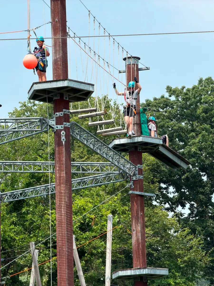 Climbers tackle a challenging high ropes bridge at the Whirlpool Adventure Course in Niagara Falls Canada.