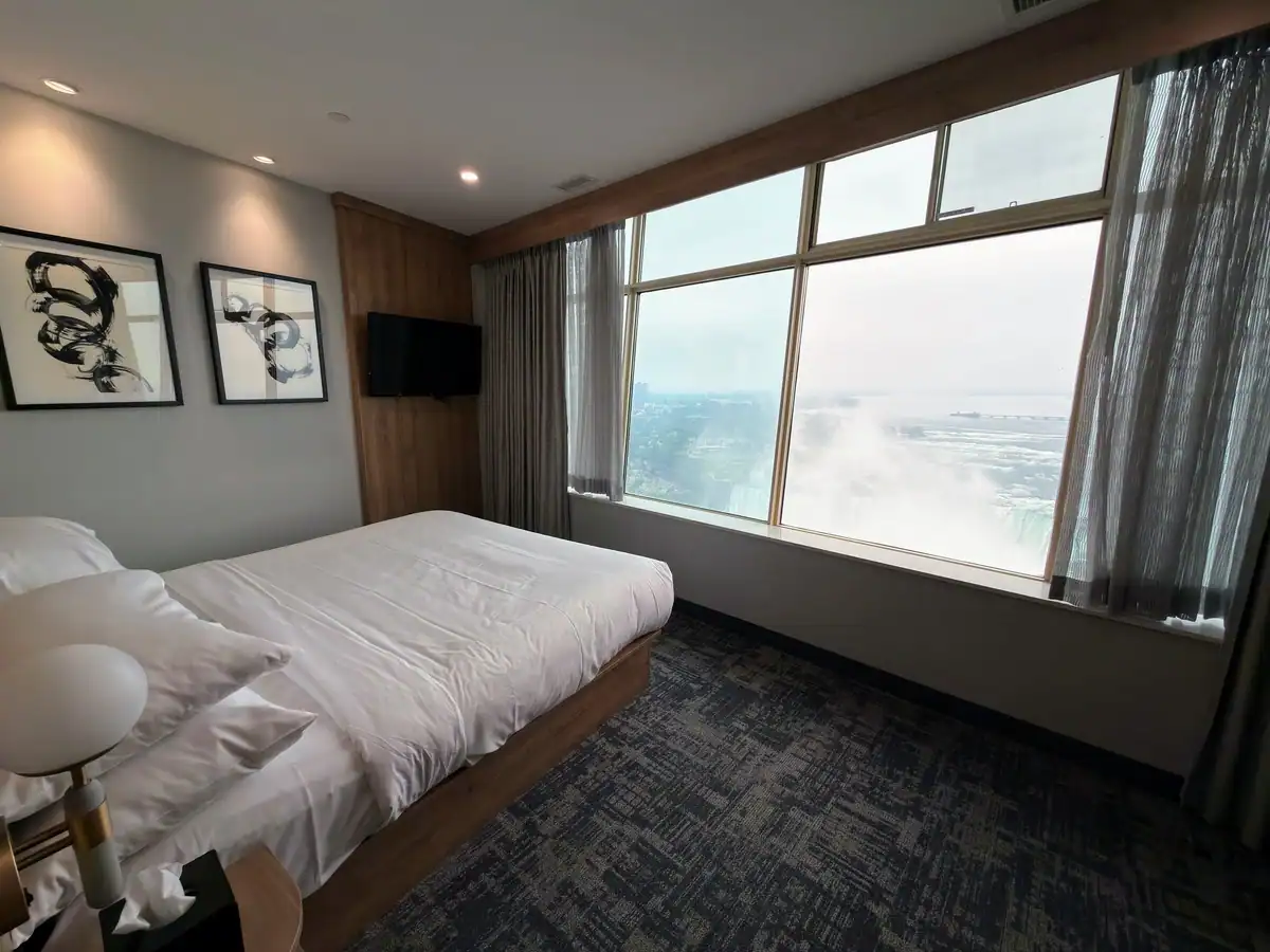 Huge windows show views of Niagara Falls from a King Standard room at the Tower Hotel in Niagara Falls Canada.