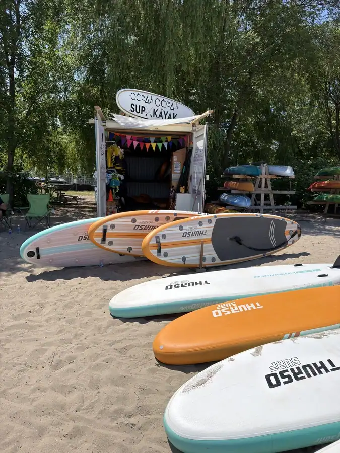 Stand-up paddleboard rentals available on the beach at Scarborough Bluffs in Toronto.